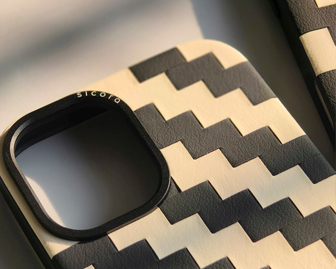 Closeup view of a sicora black zigzag iPhone 17 case.