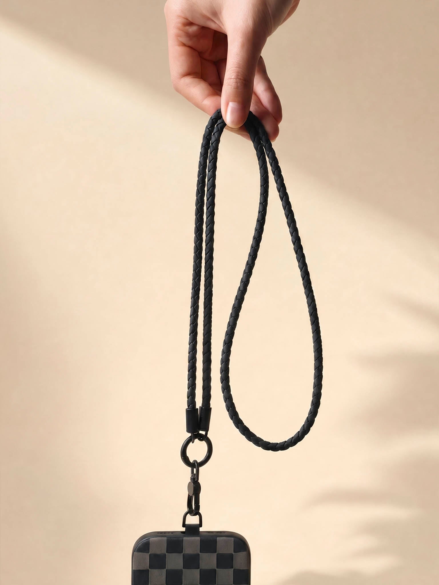 Hand holding sicora black loop lanyard