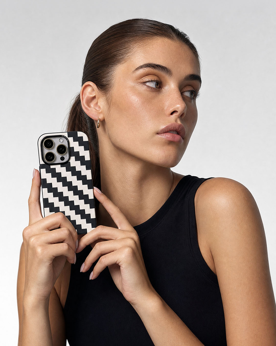 Woman holding a sicora black cream zigzag iPhone case