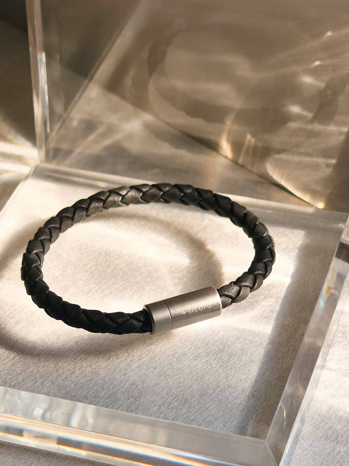 sicora black braided silio silicone vegan leather bracelet with a stainless steel metal magnetic clasp, natural sunlight