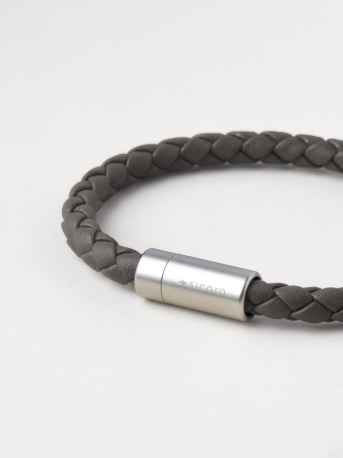 Close-up of a sicora gray / grey braided silio silicone vegan leather bracelet with a stainless steel metal magnetic clasp