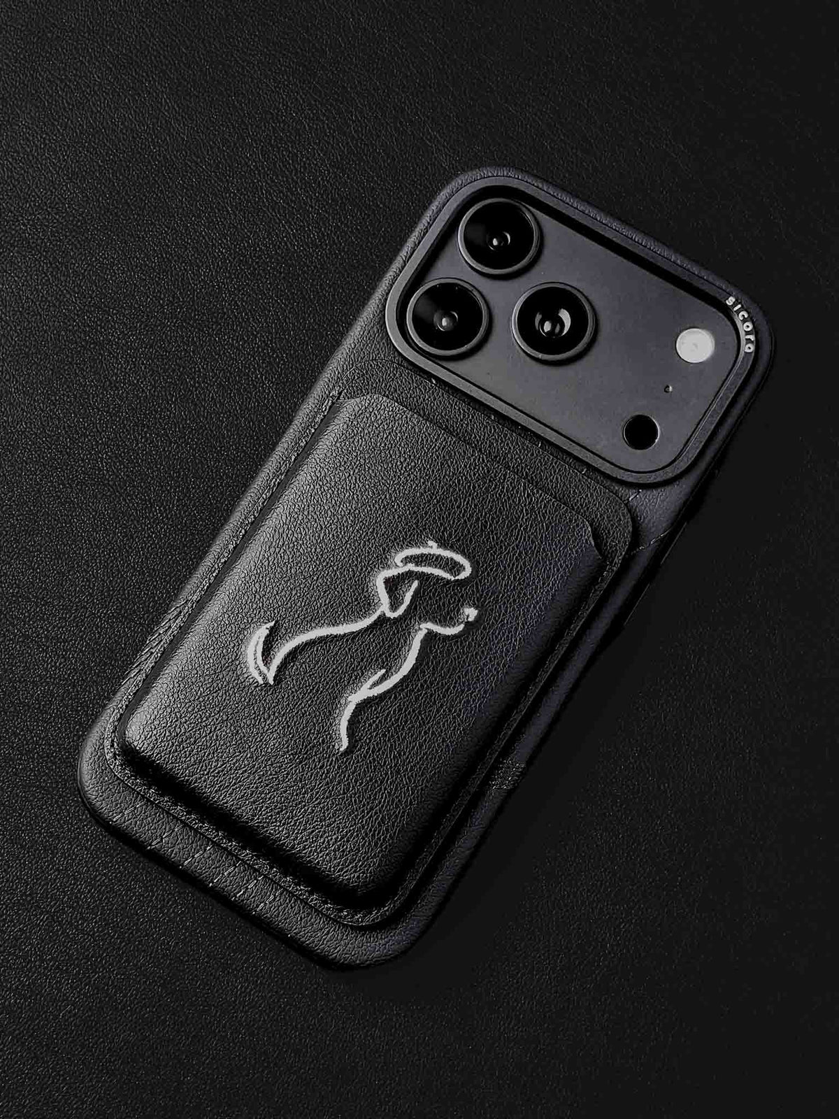sicora vegan leather graphic magnetic card wallet in black with cream white embroidered dog line-drawing on a sicora iPhone 18 pro case