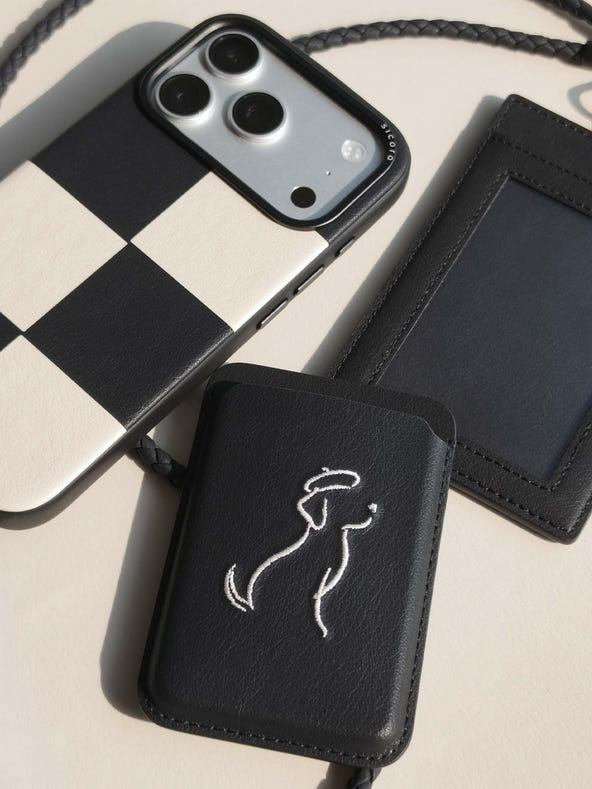 Flat-lay of sicora vegan leather products: iPhone 18 pro case, magnetic card wallet, and ID badge holder with lanyard