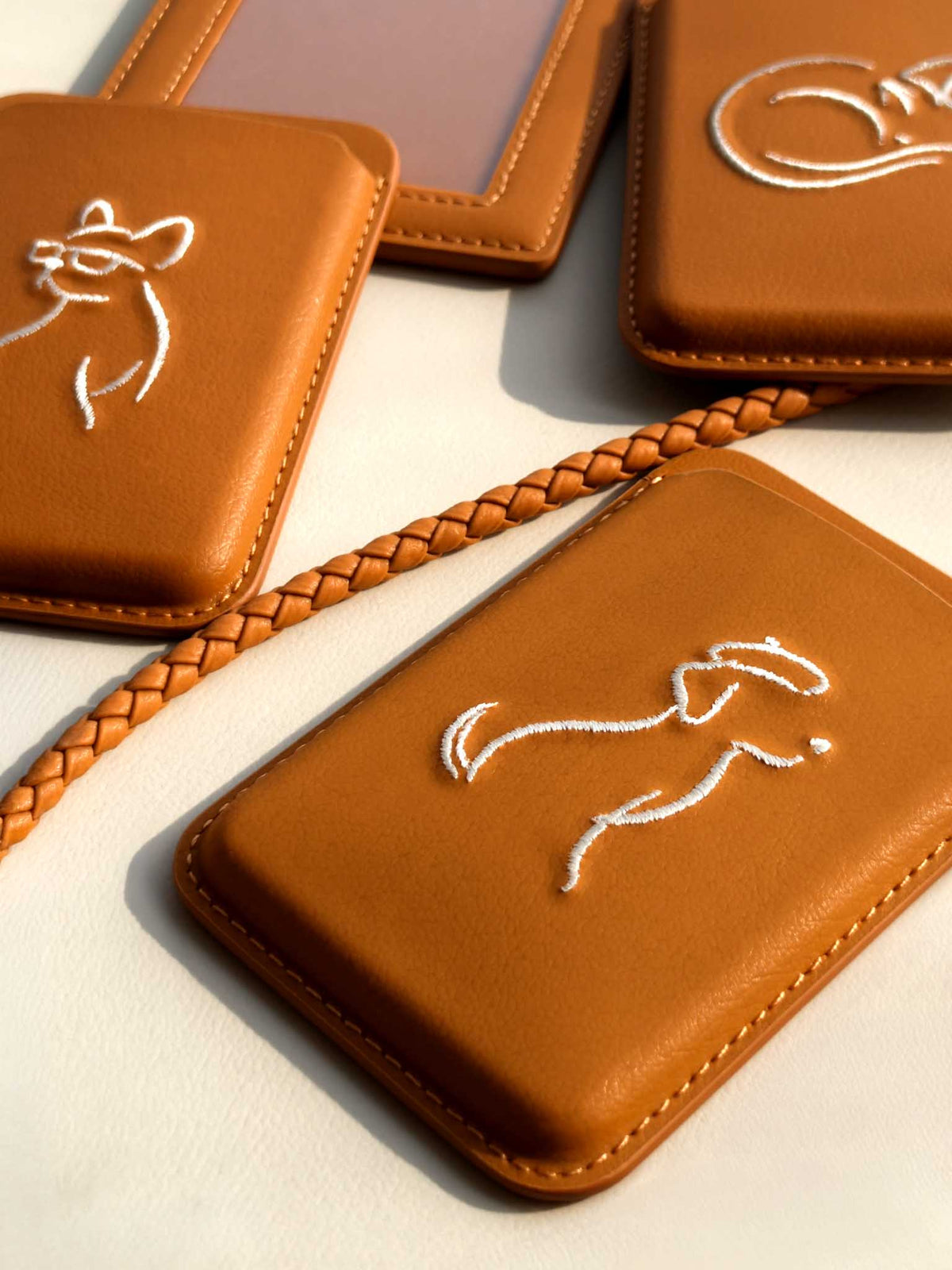 Flat-lay of sicora vegan leather products: magnetic card wallets and ID badge holder with lanyard