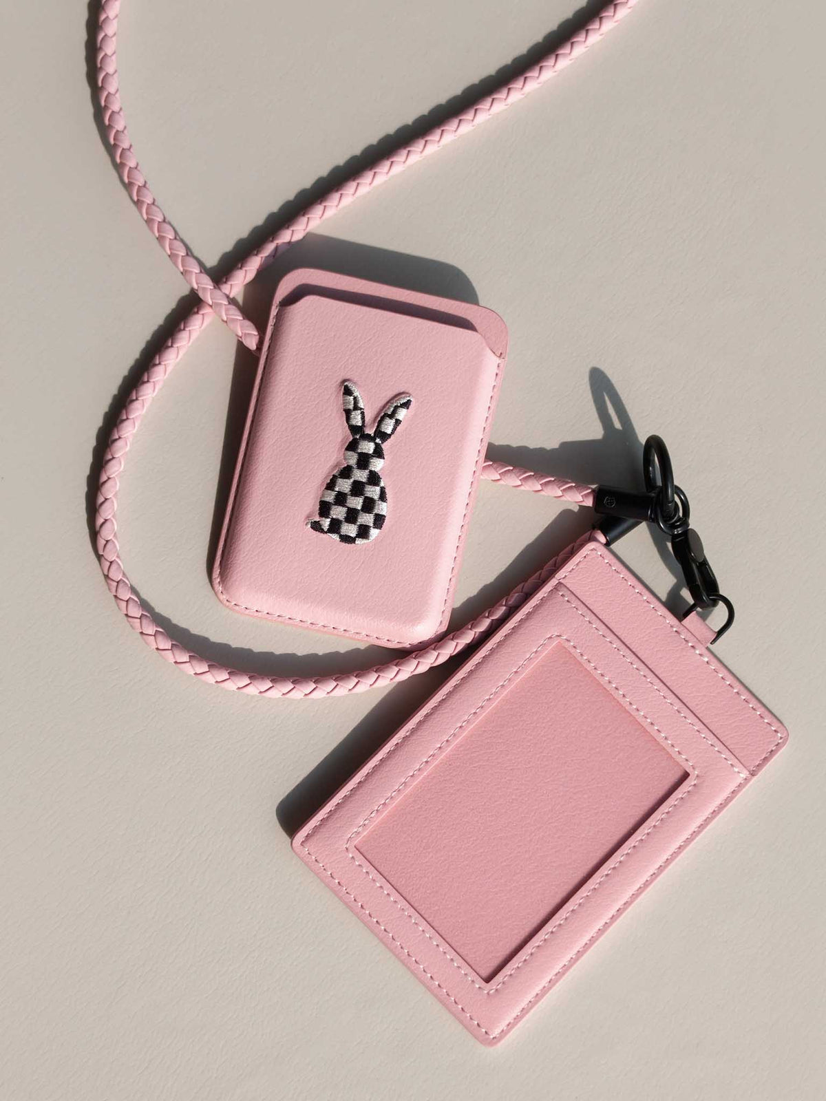 sicora vegan leather graphic magnetic card wallet in pink with black and white embroidered rabbit artwork, and a matching pink ID badge holder with lanyard