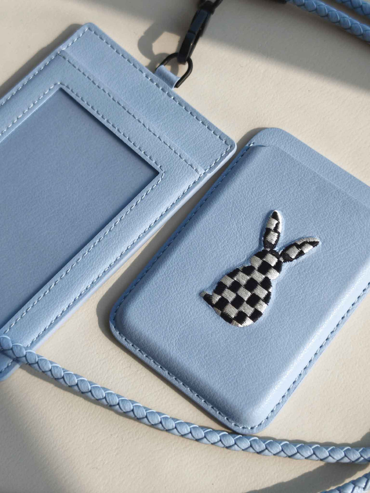 sicora vegan leather graphic magnetic card wallet in sky blue with black and white embroidered rabbit artwork, and a matching ID badge holder with lanyard