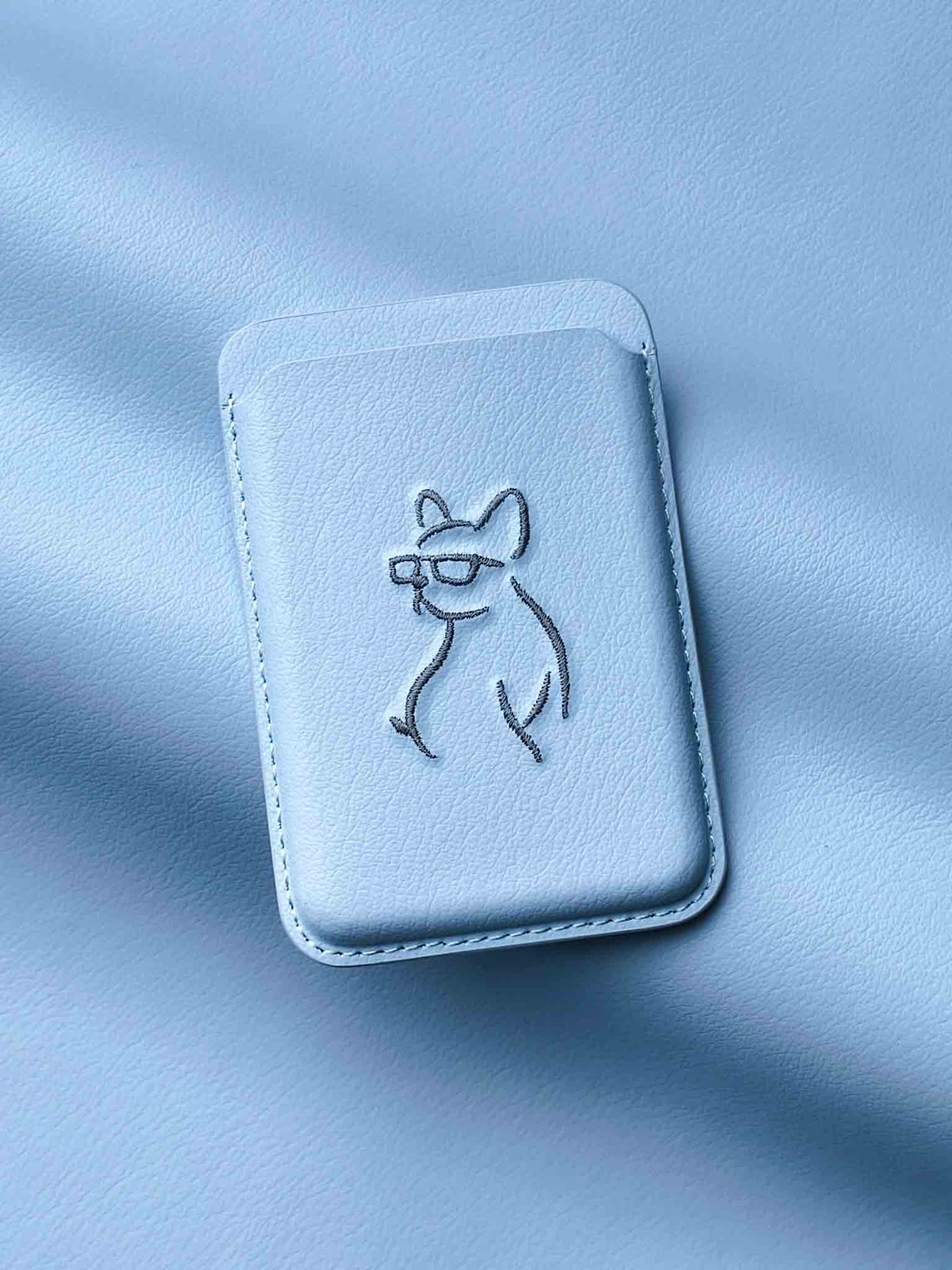 sicora vegan leather graphic magnetic card wallet in sky blue with grey blue embroidered dog line-drawing