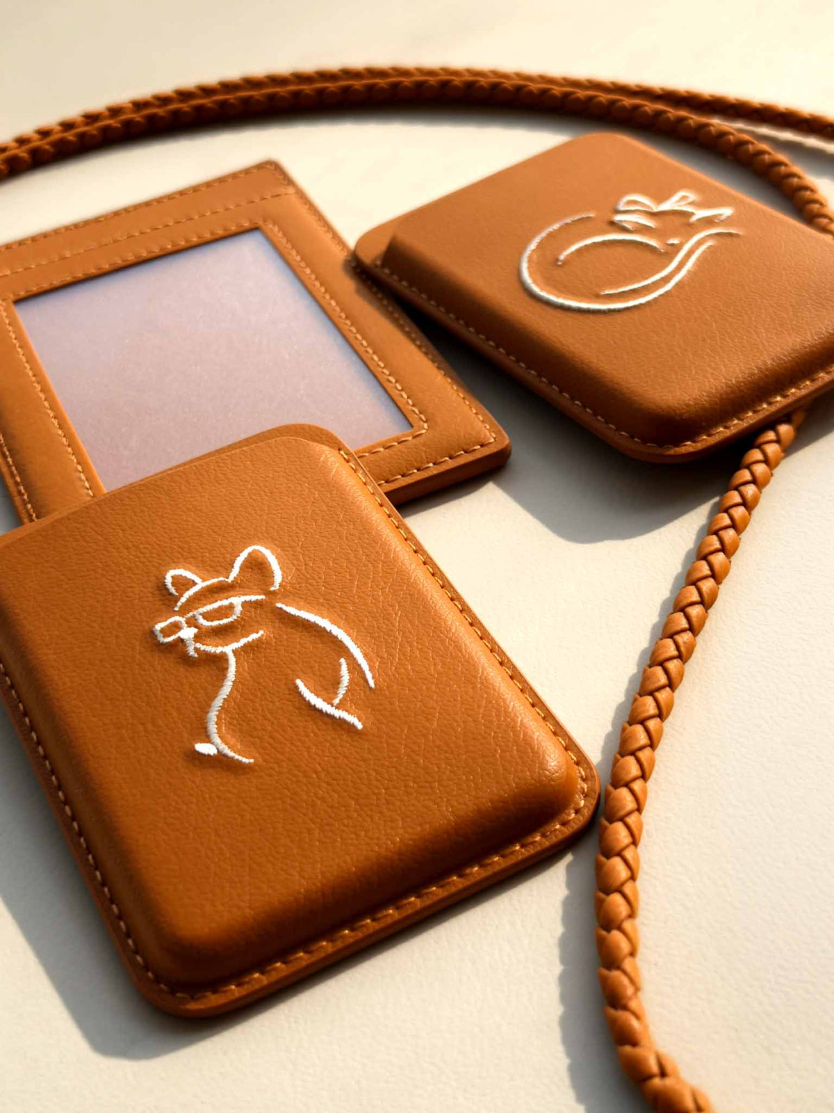 Flat-lay of sicora vegan leather products: magnetic card wallets and ID badge holder with lanyard