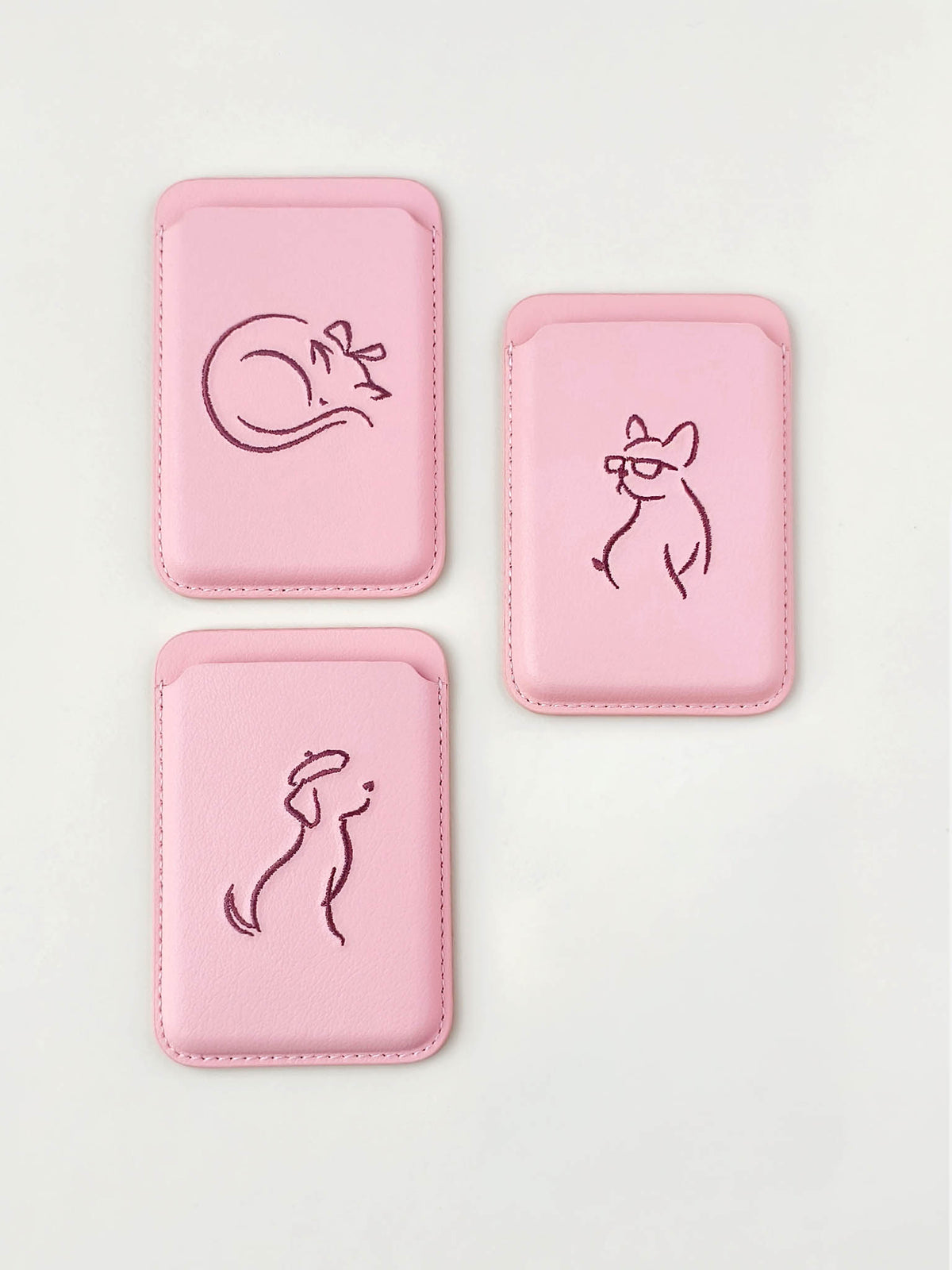 Three sicora vegan leather graphic magnetic card wallets in pink with dark burgundy embroidered minimalist animal artworks