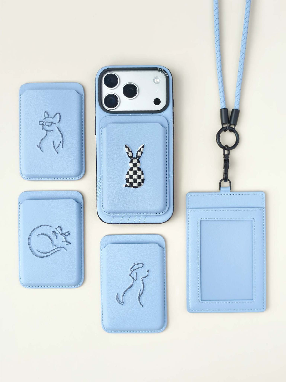 Flat-lays of sky blue sicora vegan leather accessories: iPhone 18 / 17 pro case, magnetic card wallets, and ID badge holder with lanyard