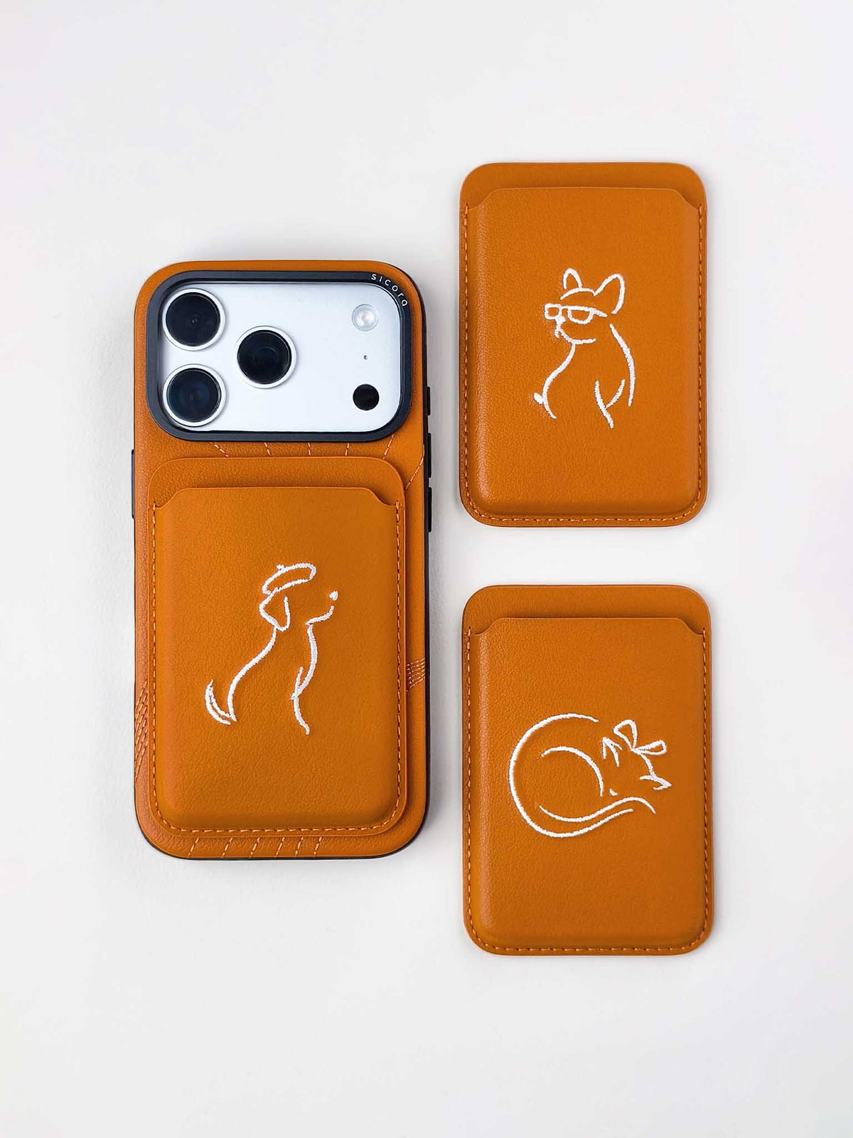 Flat-lays of toffee gold sicora vegan leather accessories: iPhone 18 / 17 pro case, and graphic magnetic card wallets
