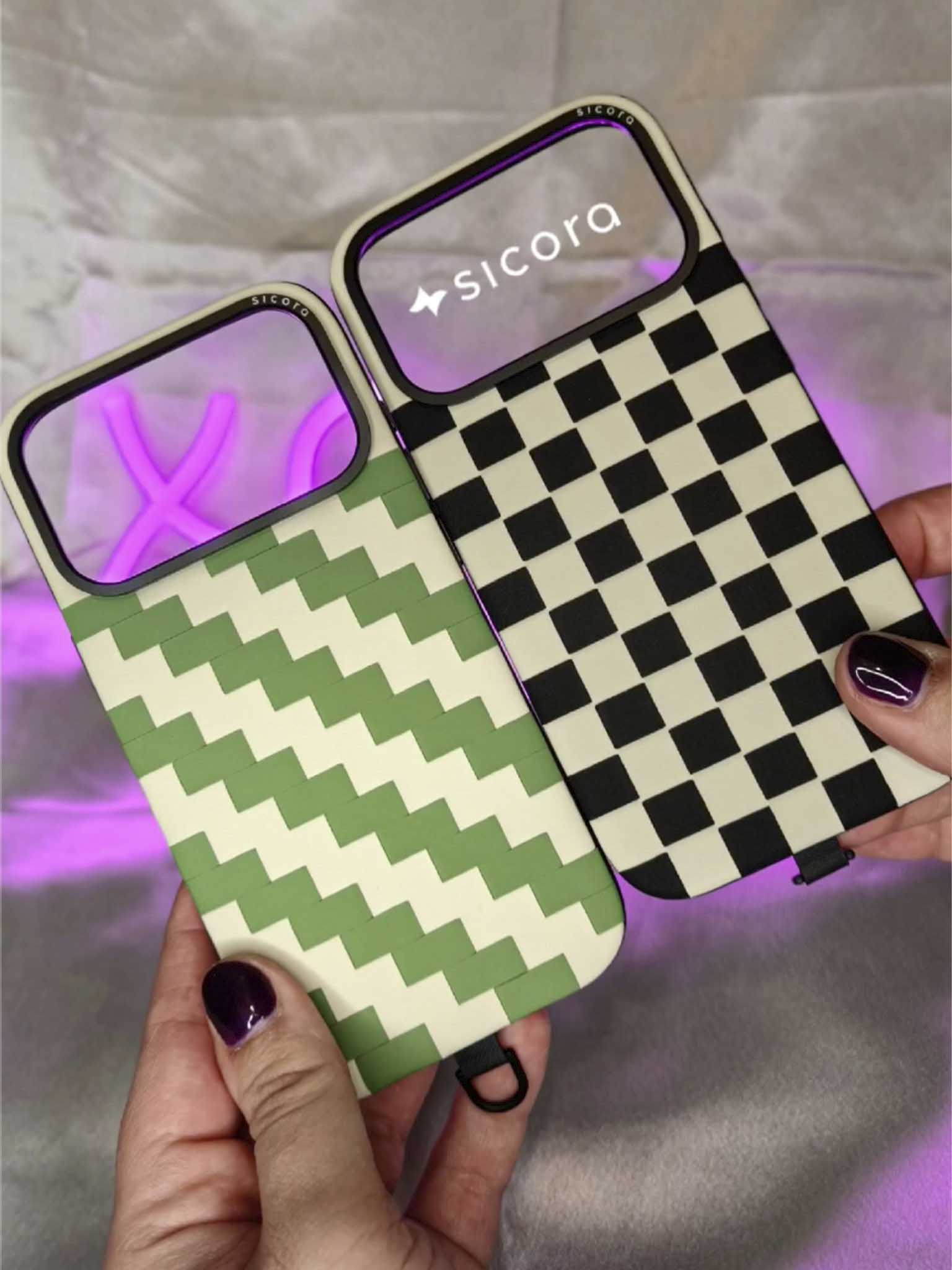 A KOL showcasing a avocado cream sicora zigzag iPhone case and a black cream sicora checkerboard iPhone case