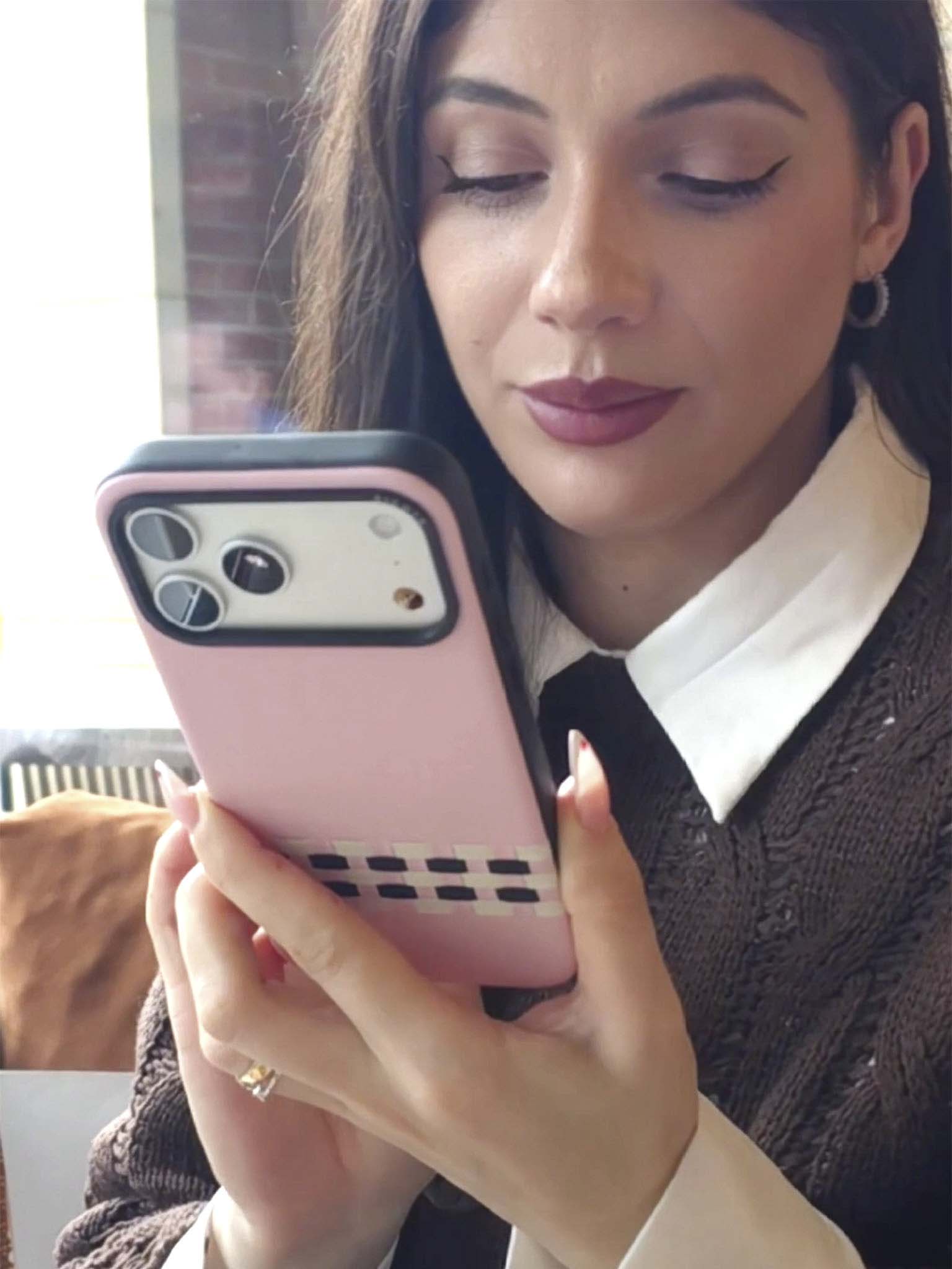 A KOL showcasing pink sicora stitchon iPhone case