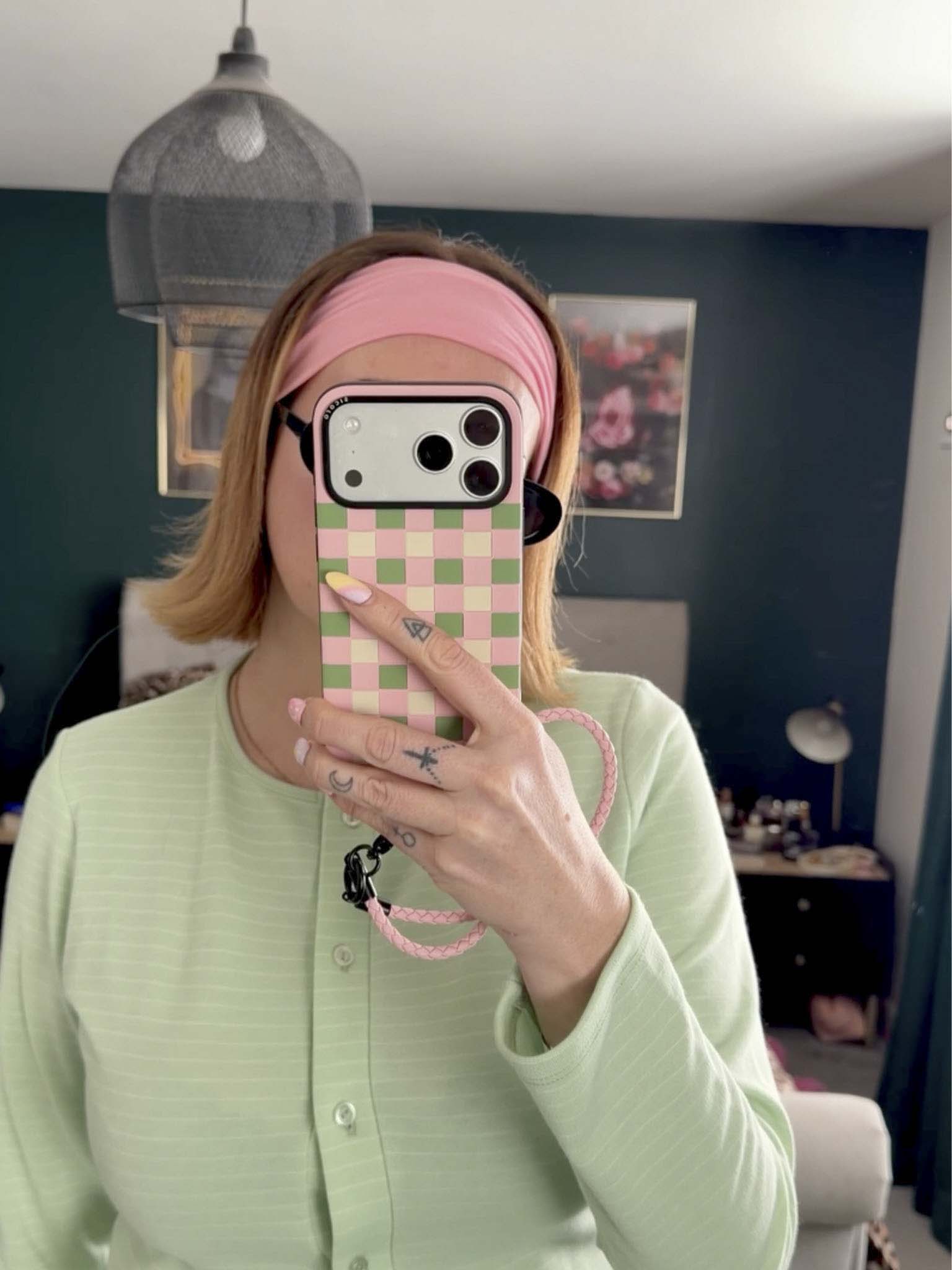 A KOL showcasing pink green cream sicora checkerboard iPhone case