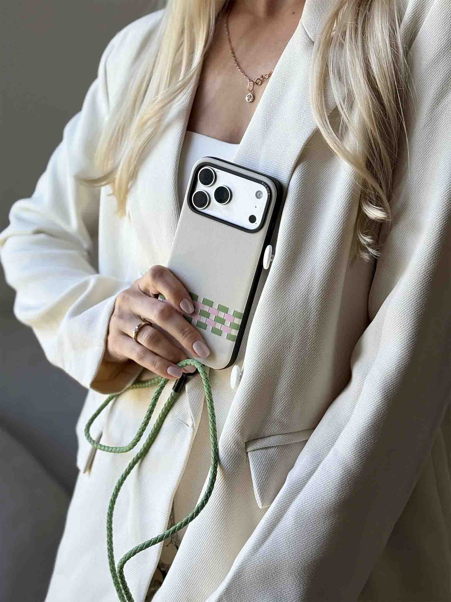 A KOL showcasing cream white sicora stitchon iPhone case with matching lanyard