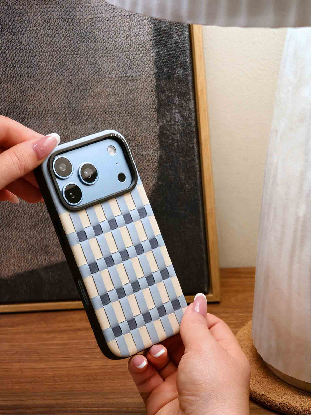 Hand holding a light blue sicora iPhone 18 pro vegan leather case, pixel case