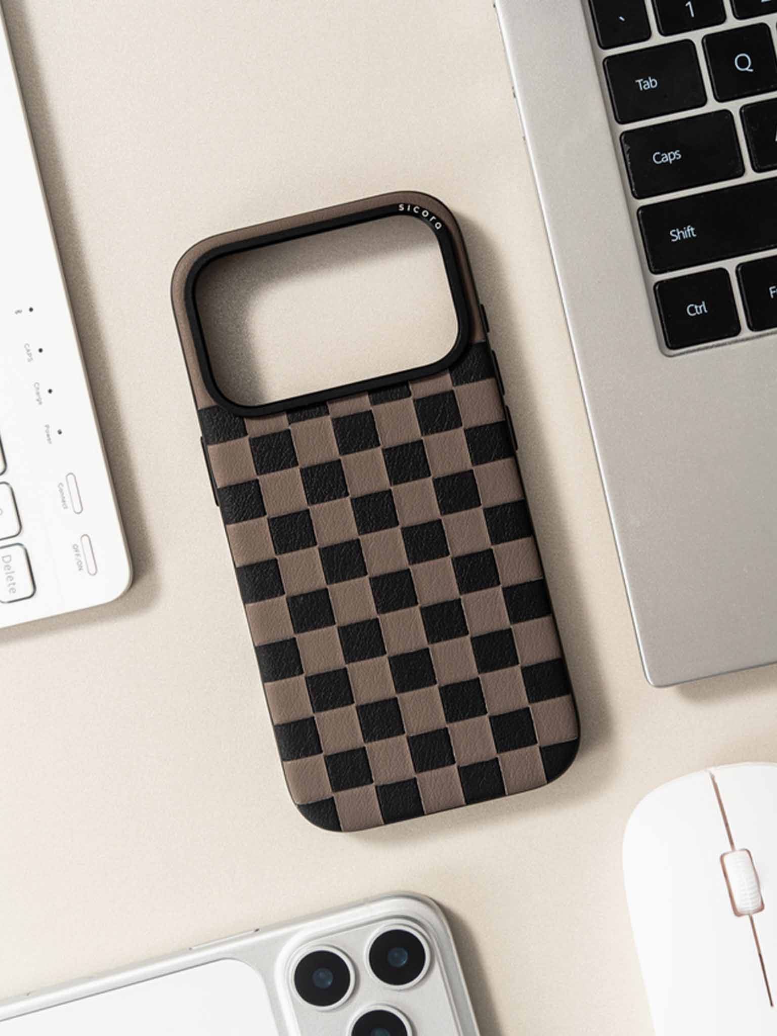Sicora checkerboard phone case with black and granite gray checkered pattern on a desk with laptop and computer mouse