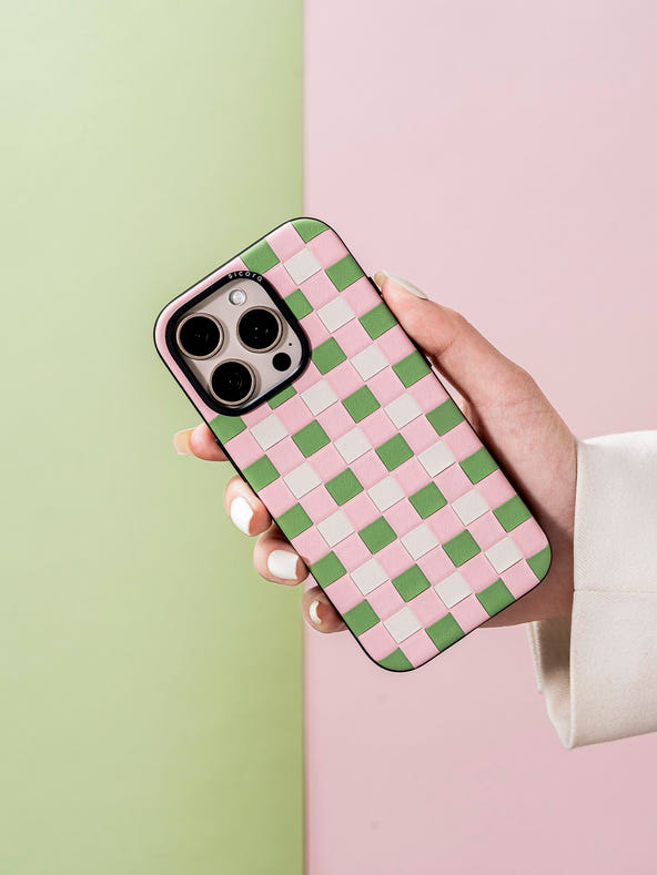 Hand holding a  sicora pink green white checkerboard phone case
