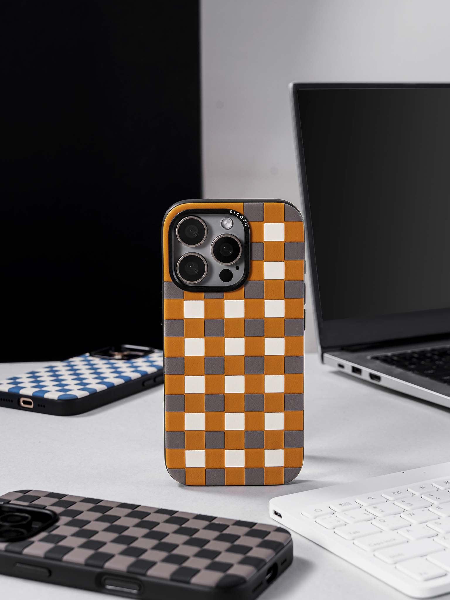 sicora checkerboard phone cases on a desk