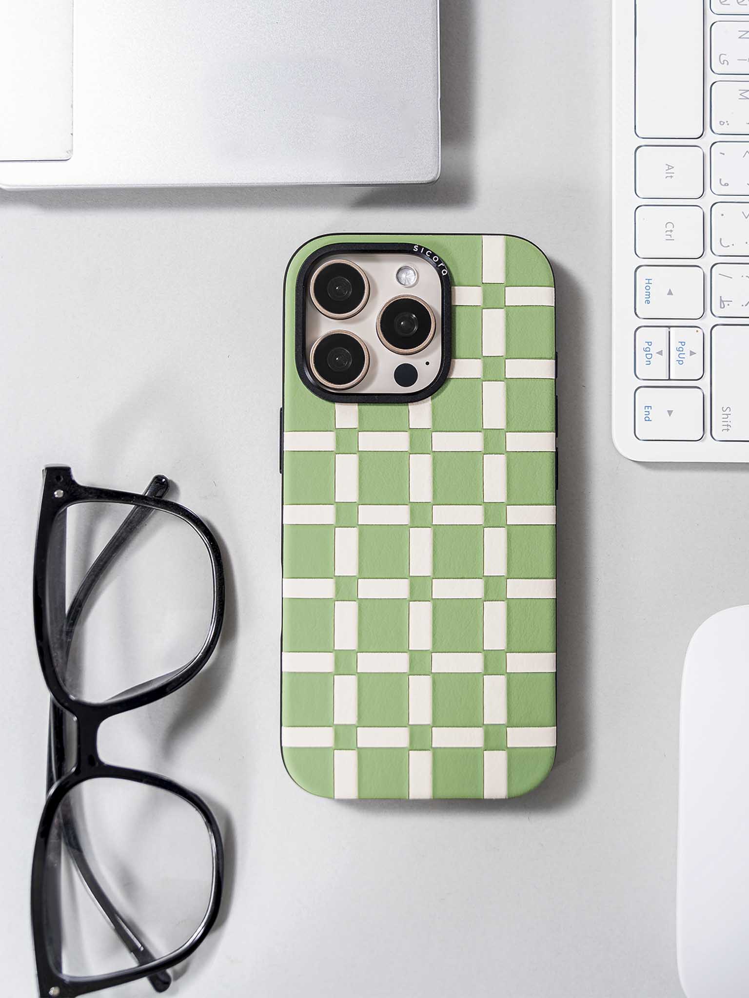 sicora green and white handwoven gridplay iPhone case on a desk