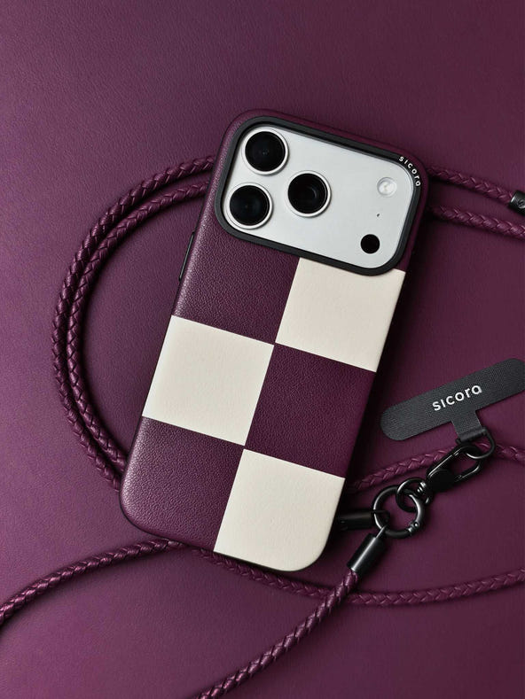 sicora iPhone 18 pro / iPhone 17 pro vegan leather phone case, macro case featuring a cherry purple and cream checkered leather marquetry pattern, braided leather lanyards and purple leather background