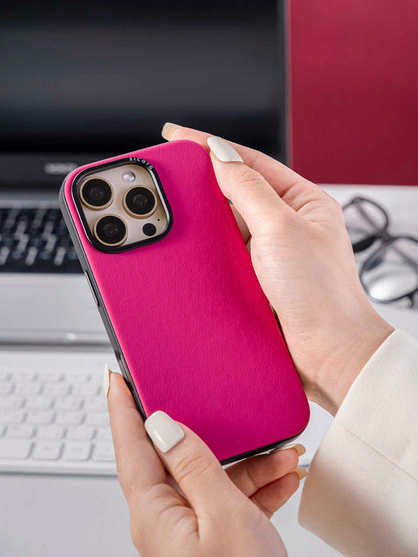 Hand holding a pink magenta sicora handmade vegan leather iPhone case