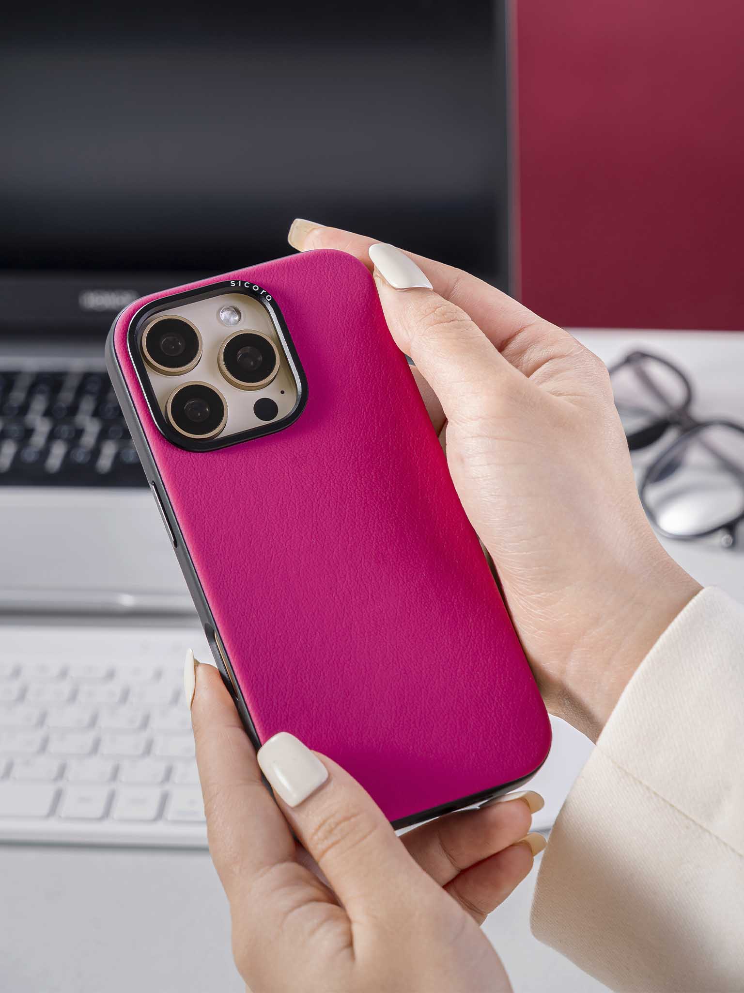 Hand holding a pink magenta sicora handmade vegan leather iPhone case