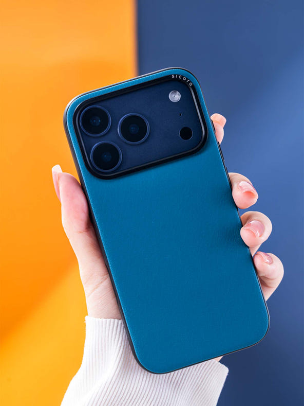 A hand holding a sea blue sicora moodblock phone case with silio silicone vegan leather