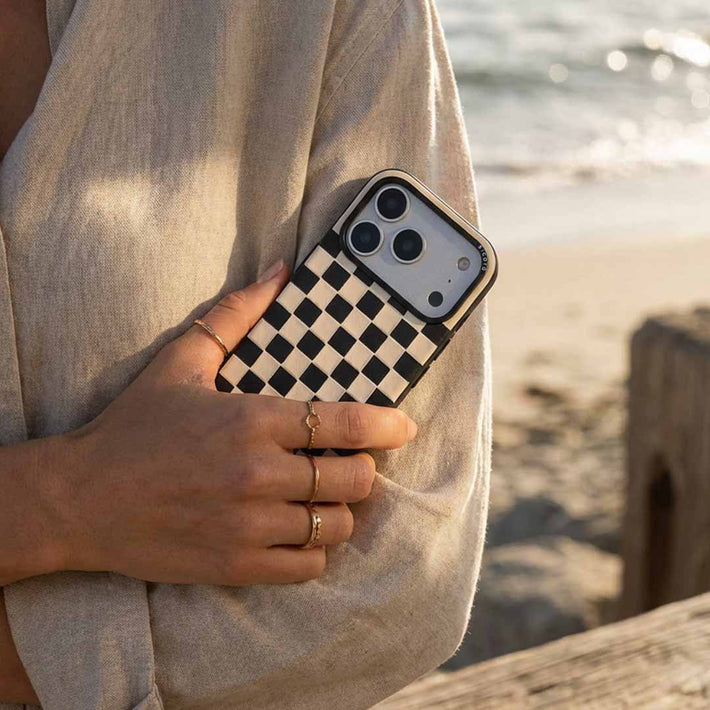 Person holding a sicora iphone checkered case 