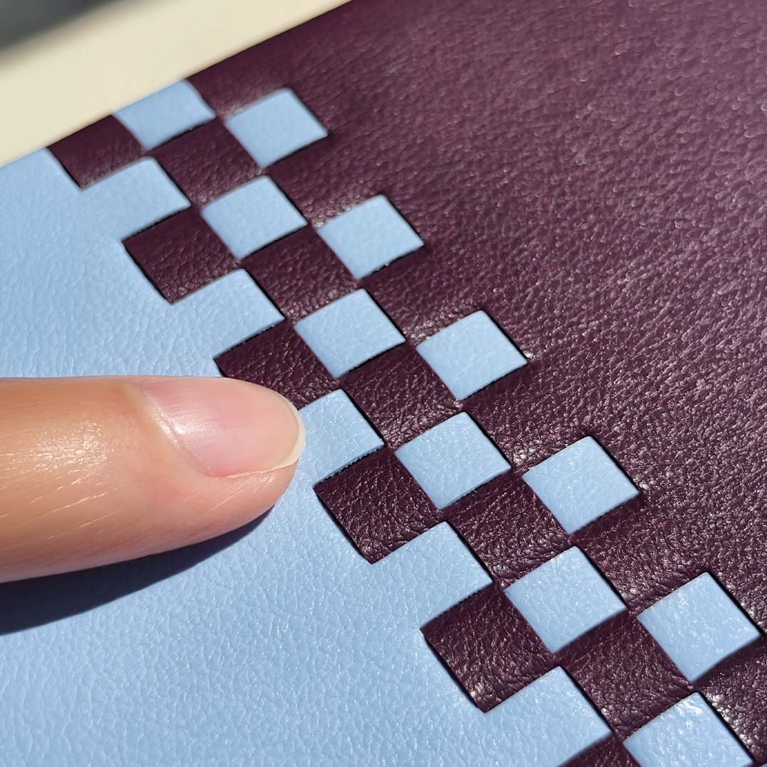 finger touching sicora silio leather textured surface