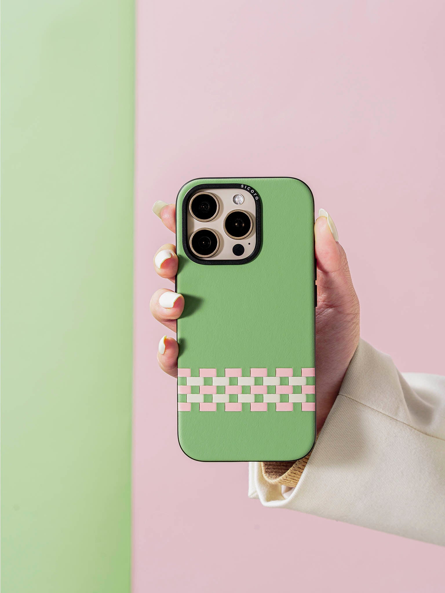 Hand holding a sicora green pink white stitchon phone case