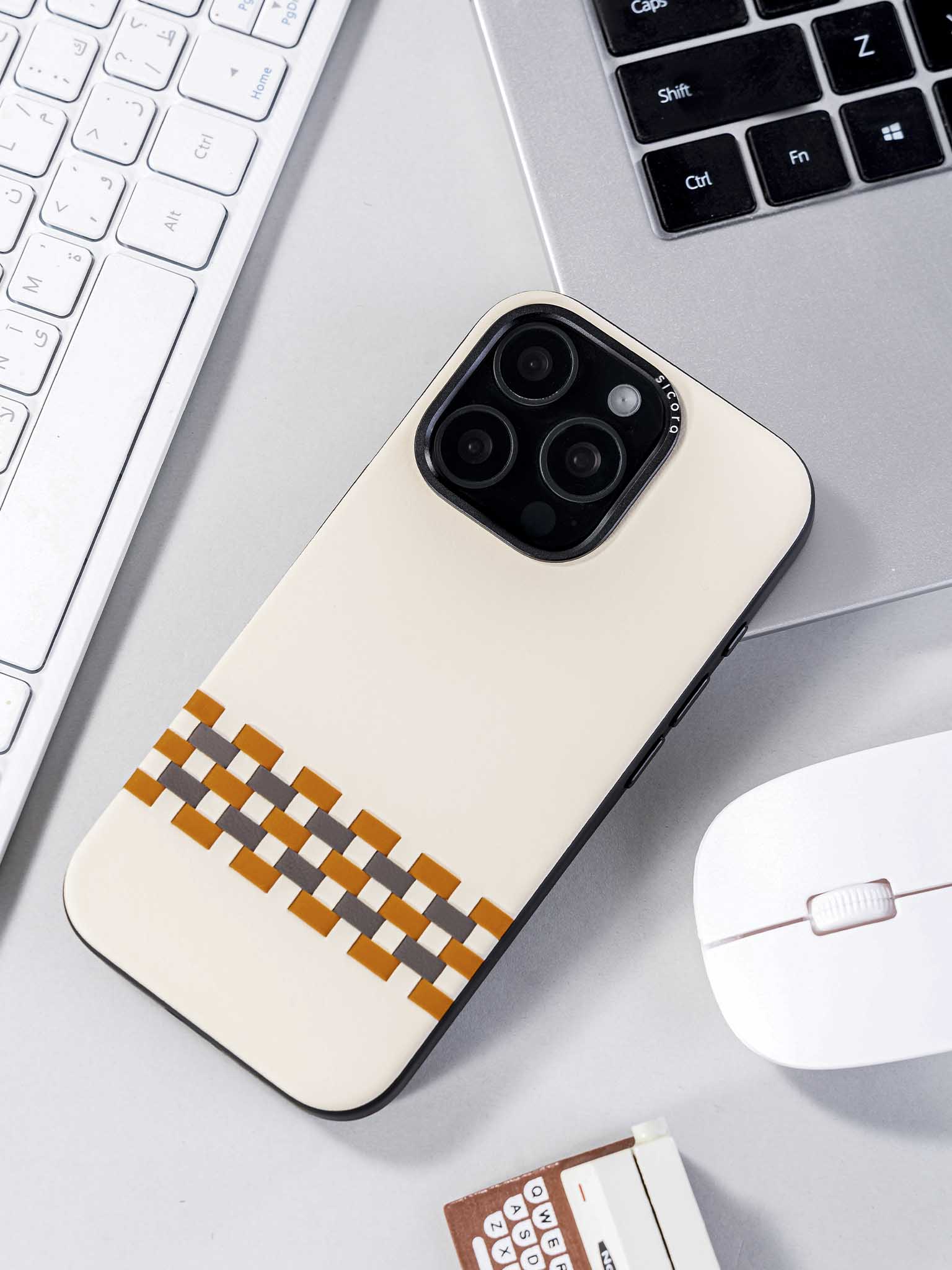 sicora white brown gray stitchon phone case on a desk