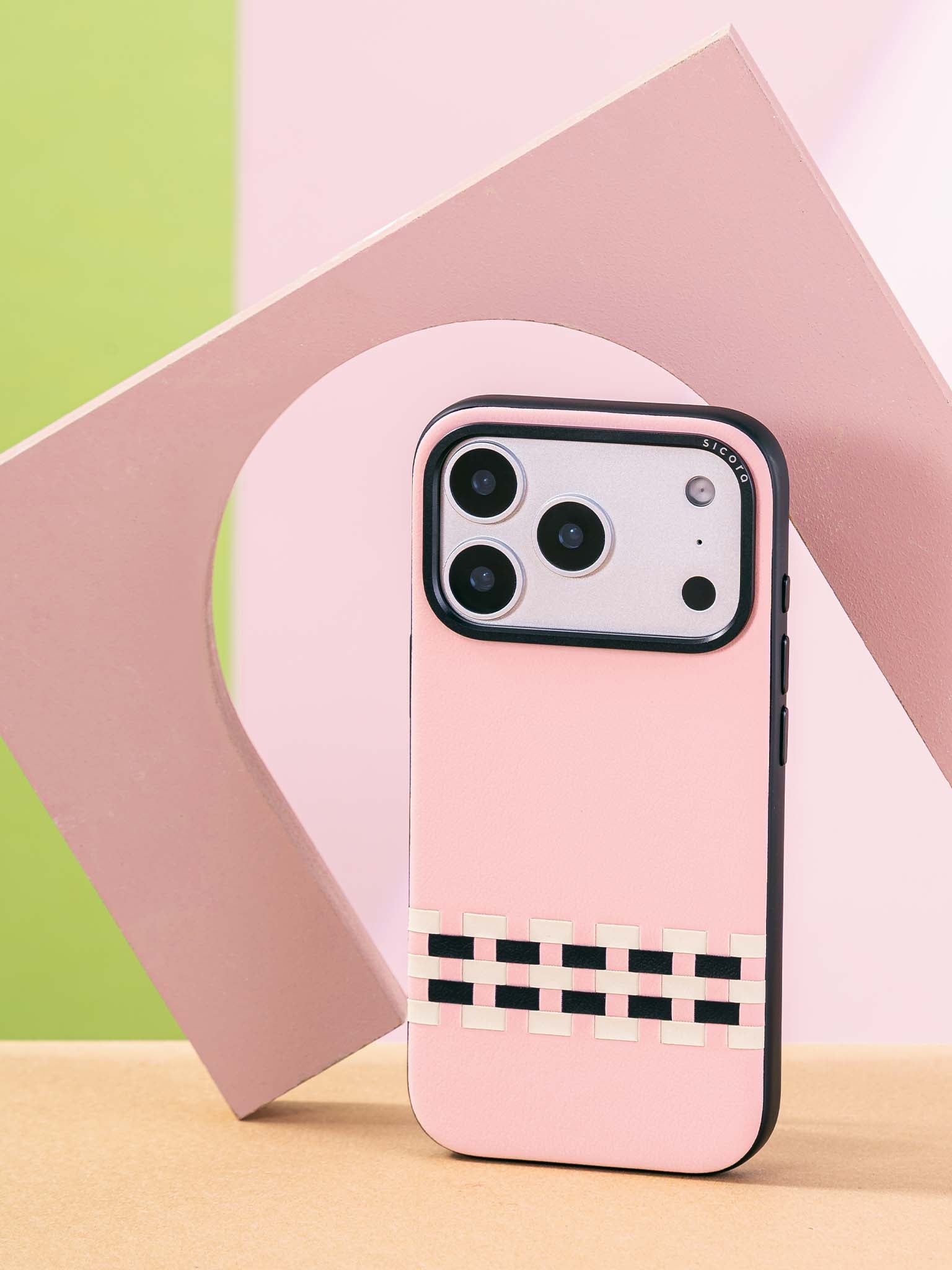 Sicora stitchon phone case with pink, cream white and black geometric pattern on a colorful background