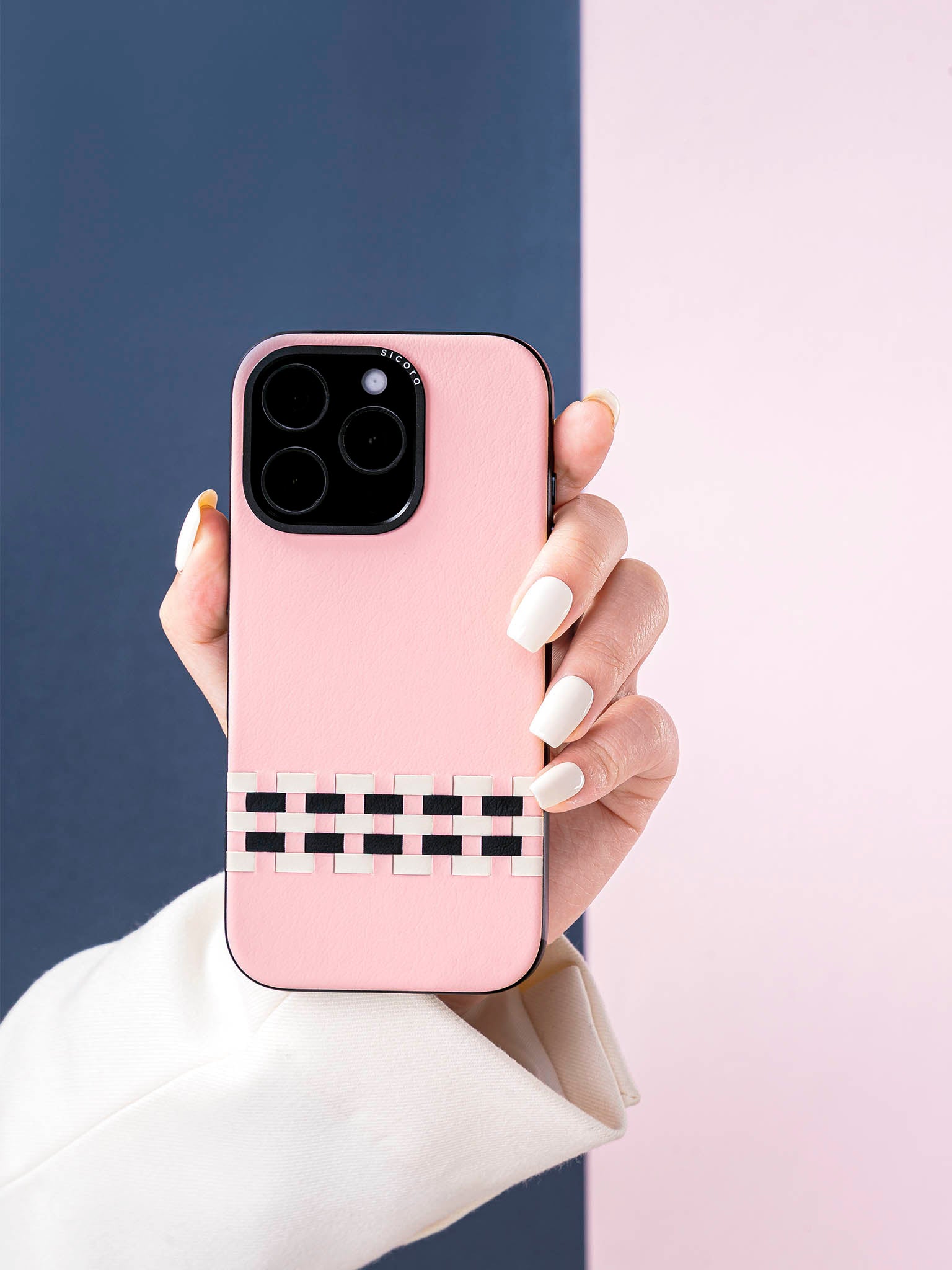 Hand holding a pink sicora stitchon phone case