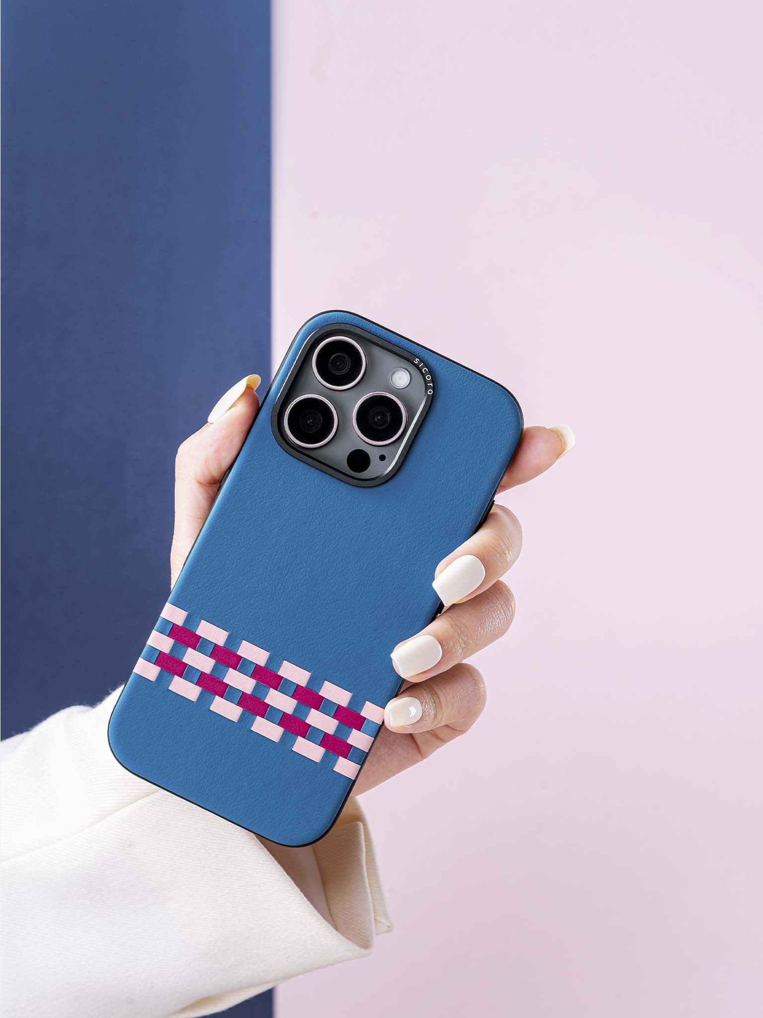 Hand holding a sicora blue pink magenta stitchon phone case