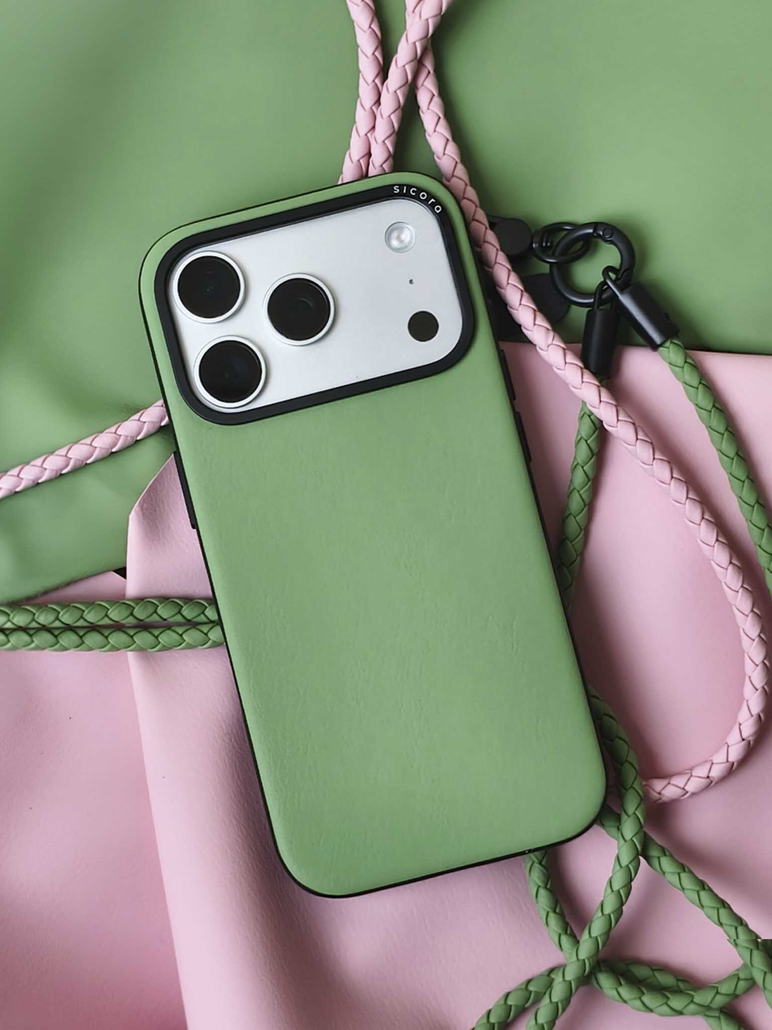 A green sicora moodblock iPhone 17 pro case with braided lanyards and black carabiner.