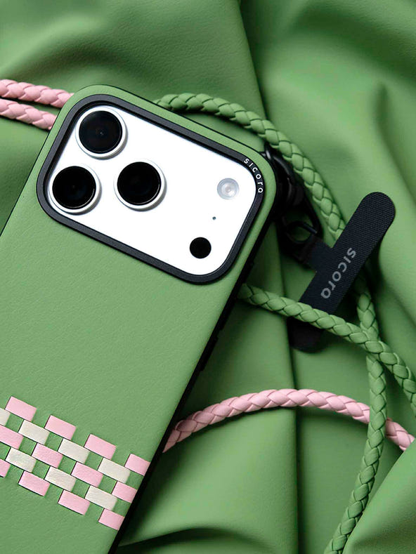 A green sicora stitchon iPhone 17 pro case with braided lanyards and black carabiner.