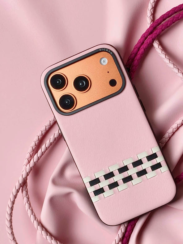 A pink sicora stitchon iPhone 17 pro case with braided lanyards.