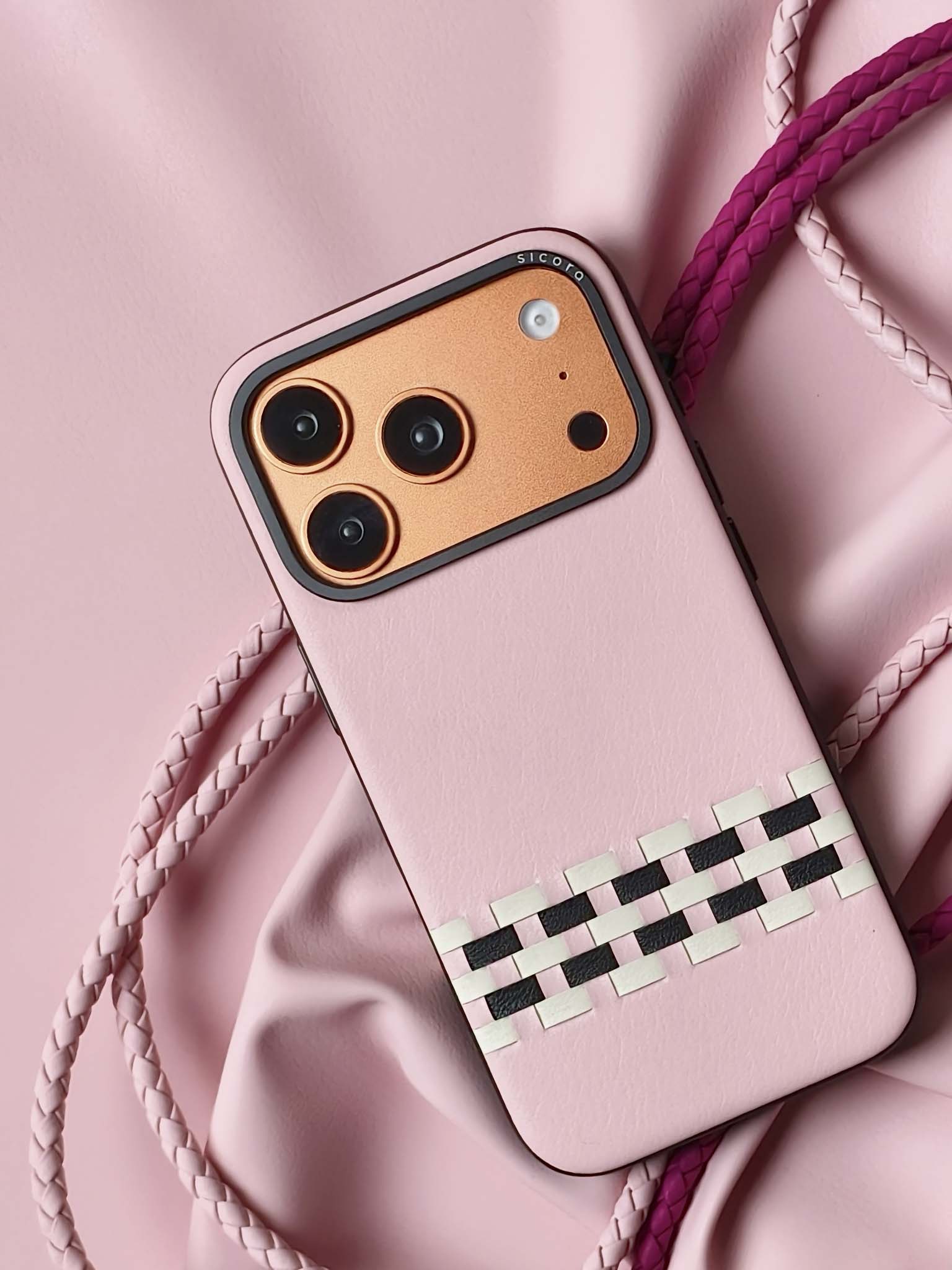 A pink sicora stitchon iPhone 17 pro case with braided lanyards.