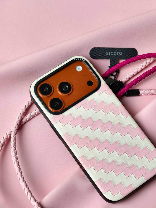 A pink sicora zigzag iPhone 17 pro case with braided lanyards and black carabiner.