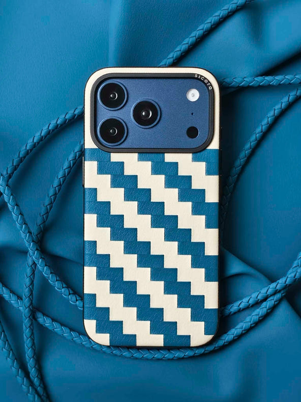 A blue sicora zigzag iPhone 17 pro case with braided lanyards and black carabiner.