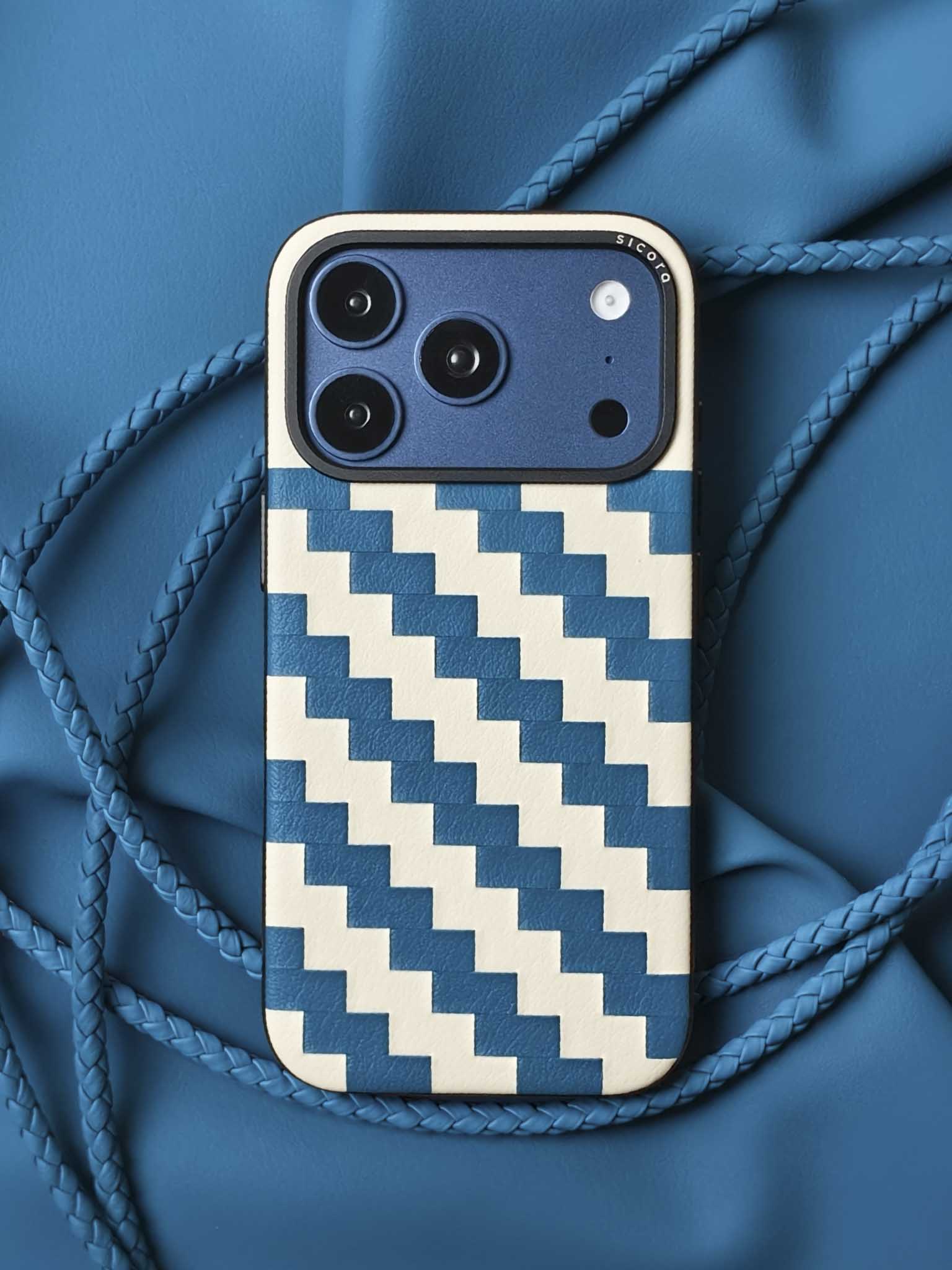 A blue sicora zigzag iPhone 17 pro case with braided lanyards and black carabiner.