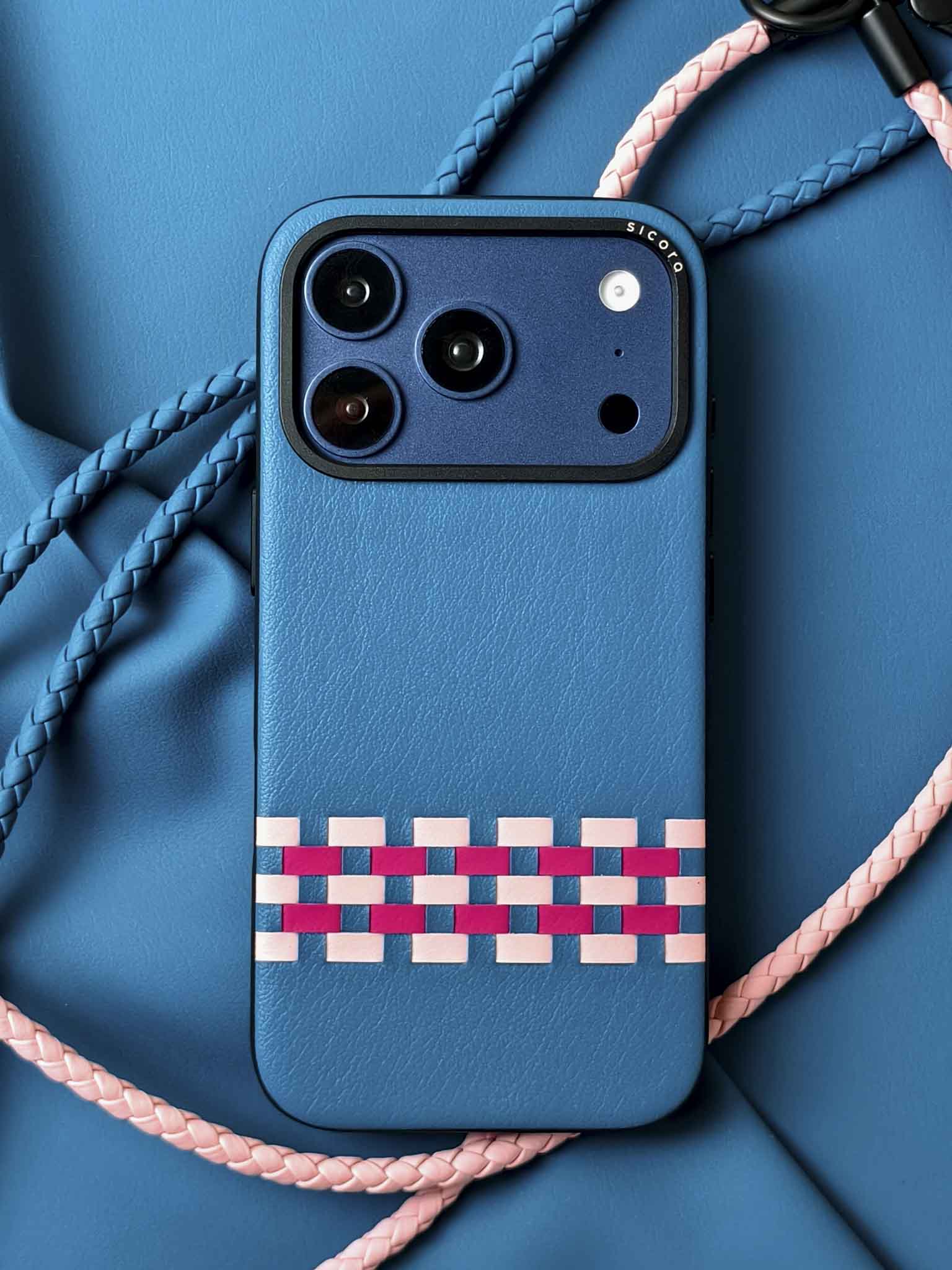 A blue sicora stitchon iPhone 17 pro case with braided lanyards.