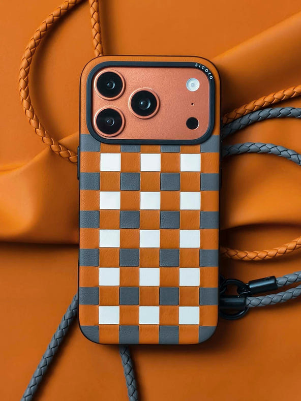 An orange brown sicora zigzag iPhone 17 pro case with braided lanyards.