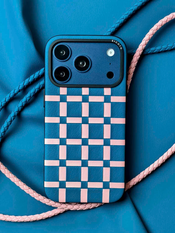 A blue sicora gridplay iPhone 17 pro case with braided lanyards and black carabiner.