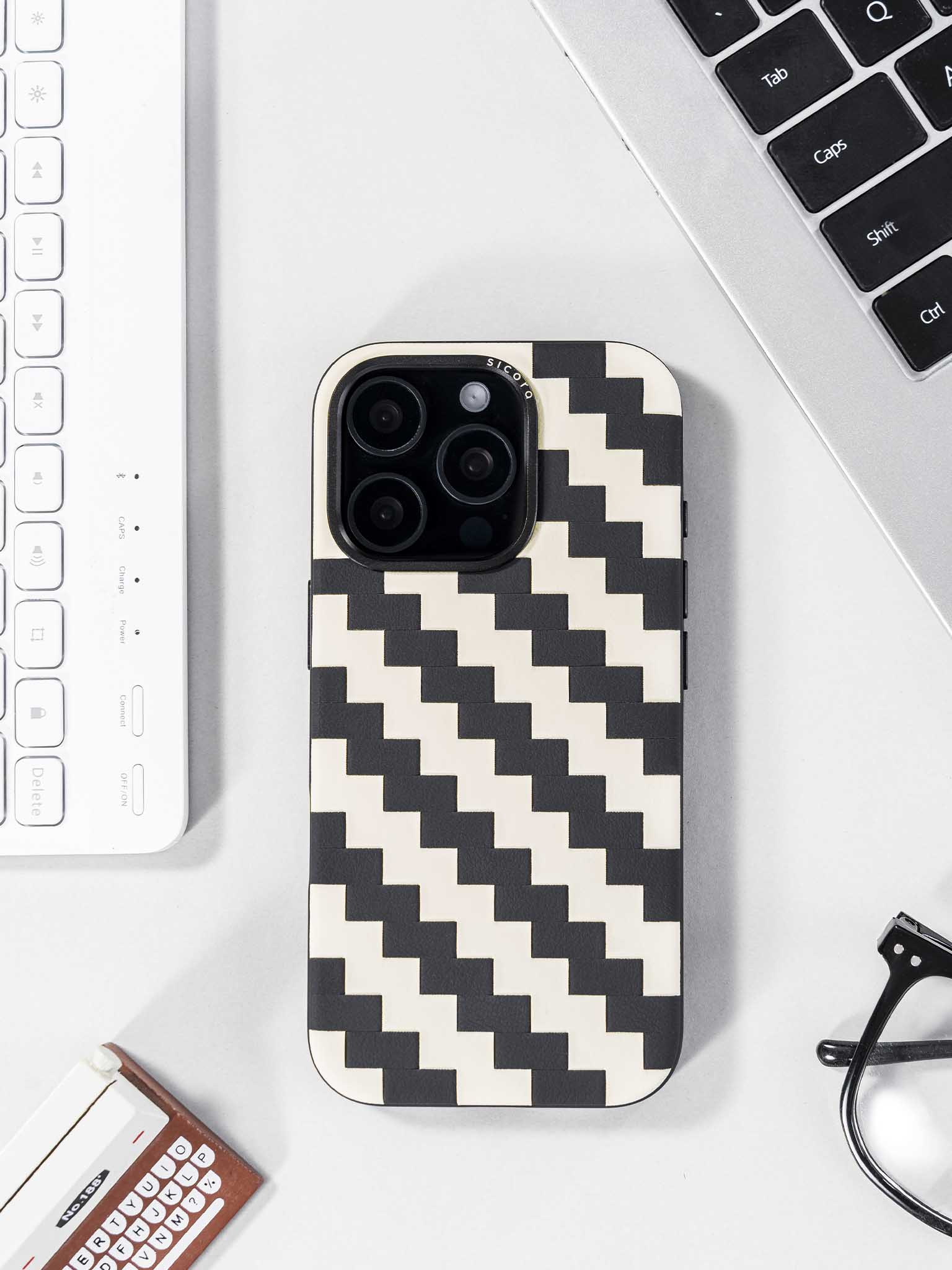 sicora black and white zigzag phone case on a desk
