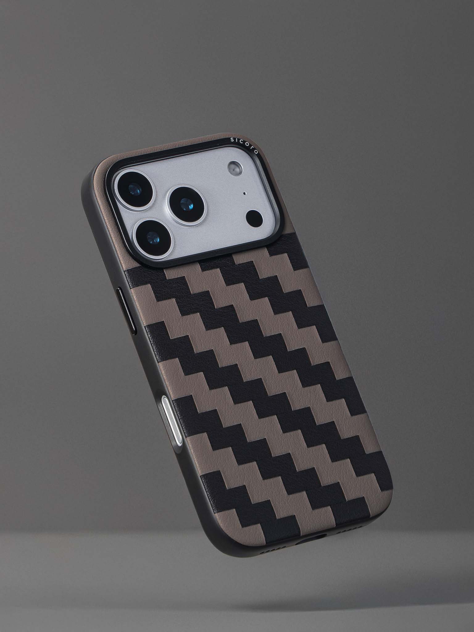 Sicora zigzag phone case with black and granite gray zigzag pattern on a gray background