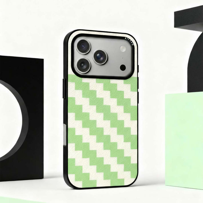 A sicora zigzag iPhone case in silio silicone vegan leather with avocado green and cream white zigzag pattern on an abstract background